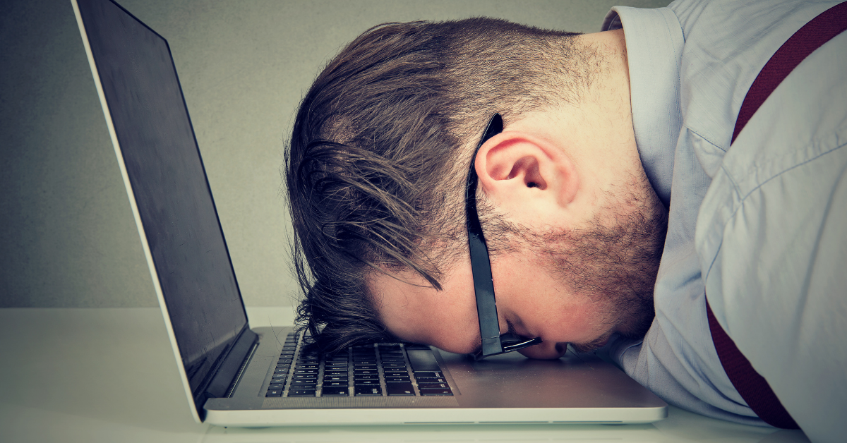 Man laying face down on his laptop