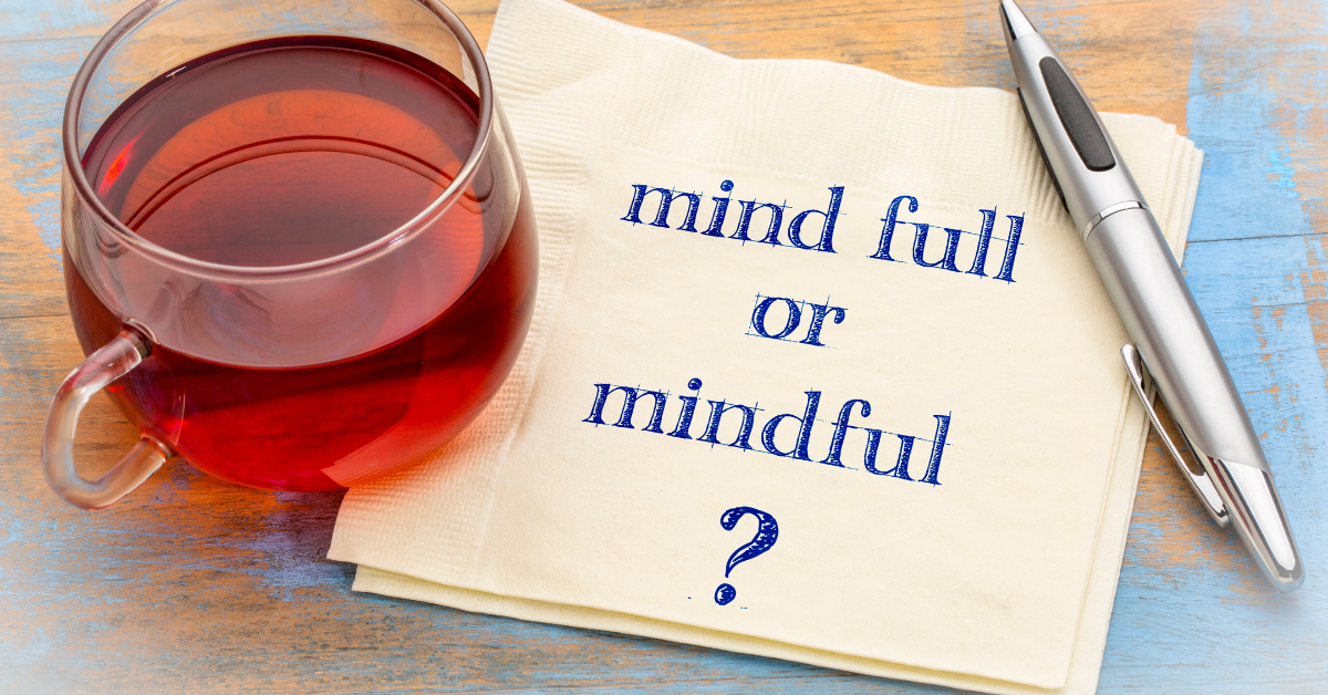 Coffee cup and napkin with "mind full or mindful" written on the napkin